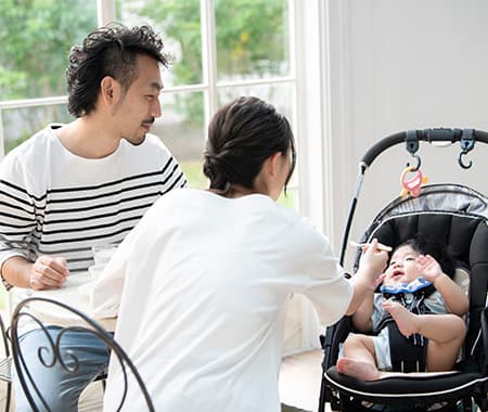 赤ちゃんと両親が席に座っている画像